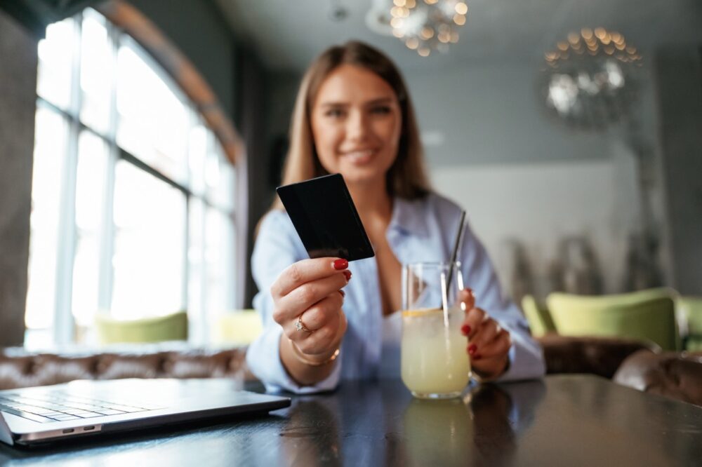 giving the credit card young beautiful woman is i 2026 03 24 05 01 39 utc Large