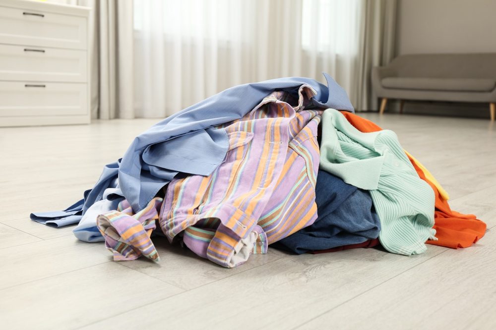 pile of clothes on a wooden floor indoors 2026 03 27 00 51 50 utc Large